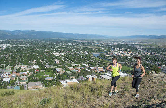 two women running on trail above missoula
